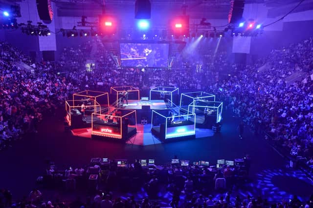 A packed arena around a lit stage